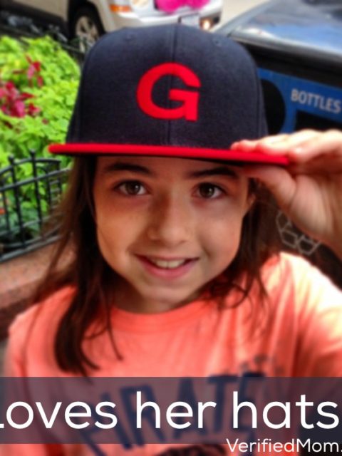 Little girl loves her baseball hats