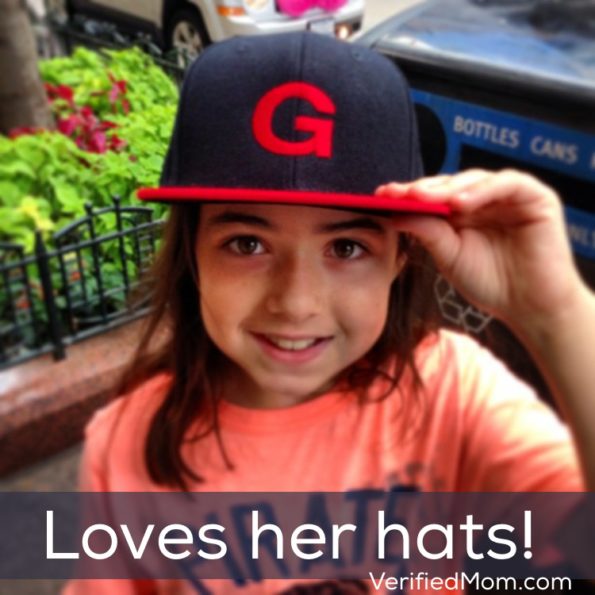 Little girl loves her baseball hats